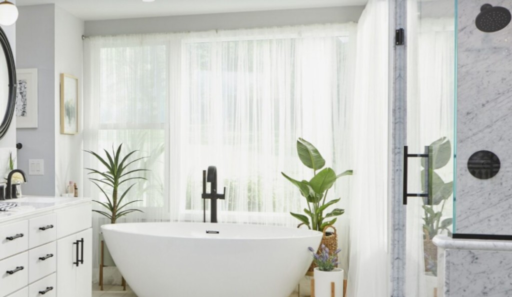 Spa-like bathroom remodel with freestanding tub, white vanity, and marble shower—Southern New Hampshire