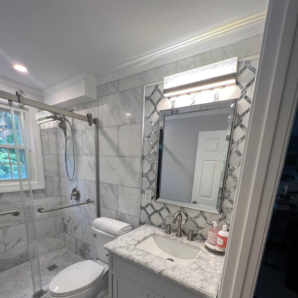 Modern walk-in shower and light wood vanity